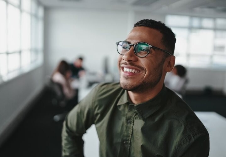 A happy male employee in a workplace