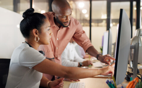 Two employees collaboratively working in the office