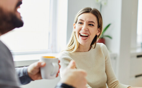 A young businesswoman smiling and talking to a male colleague