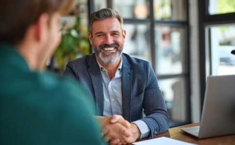 Happy matured businessman in a meeting