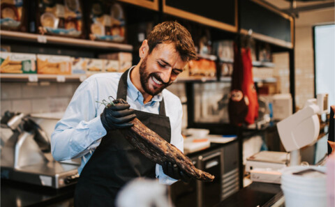 Cafe worker looking at the meat supplied